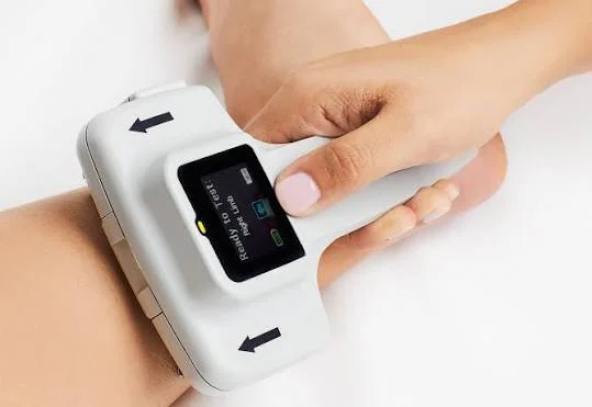 DPNCheck handheld nerve conduction device held against the ankle